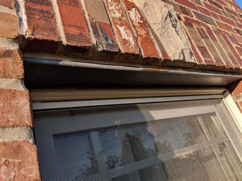 metal hardware above windows of an old house|metal plate above windows.